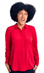 Sticker - Young african american girl wearing casual clothes angry and mad screaming frustrated and furious, shouting with anger. rage and aggressive concept.