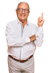 Poster - Senior caucasian man wearing business shirt and glasses with a big smile on face, pointing with hand and finger to the side looking at the camera.