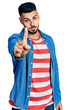 © Krakenimages.com - Young hispanic man with beard wearing casual denim jacket pointing with finger up and angry expression, showing no gesture