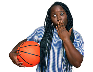 Sticker - Young black woman with braids holding basketball ball covering mouth with hand, shocked and afraid for mistake. surprised expression