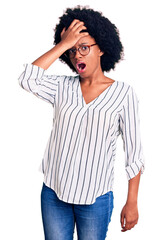 Sticker - Young african american woman wearing casual clothes and glasses surprised with hand on head for mistake, remember error. forgot, bad memory concept.