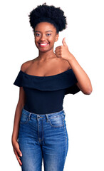 Poster - Young african american woman wearing casual clothes smiling happy and positive, thumb up doing excellent and approval sign