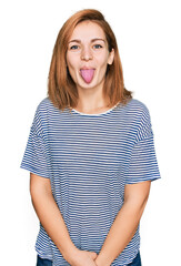 Wall Mural - Young caucasian woman wearing casual clothes sticking tongue out happy with funny expression. emotion concept.