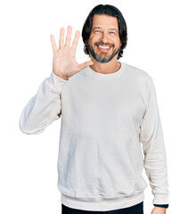 Canvas Print - Middle age caucasian man wearing casual clothes showing and pointing up with fingers number five while smiling confident and happy.