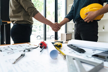 Engineer and contractor shaking hands success of the project work together