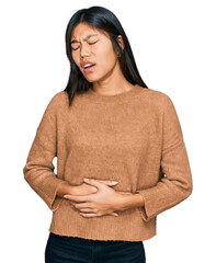 Sticker - Beautiful young asian woman wearing casual winter sweater with hand on stomach because nausea, painful disease feeling unwell. ache concept.