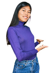 Sticker - Beautiful young asian woman wearing casual clothes inviting to enter smiling natural with open hand