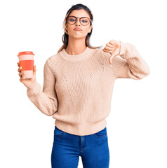 Poster - Young beautiful woman wearing glasses holding takeaway cup of coffee with angry face, negative sign showing dislike with thumbs down, rejection concept