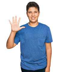 Sticker - Teenager hispanic boy wearing casual clothes showing and pointing up with fingers number five while smiling confident and happy.