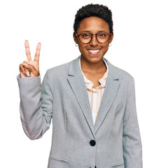 Sticker - Young african american woman wearing business clothes smiling looking to the camera showing fingers doing victory sign. number two.