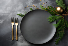 An empty dark slate dinner plate ready for a christmas celebration meal