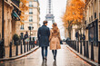 © VisualProduction - Couple walking in Paris. Happy couple going on vacation together, walking down the streets of Paris. Generative AI