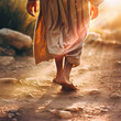Closeup of Jesus walking alone on an old pathway outside.