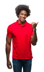 Wall Mural - afro american man over isolated background smiling with happy face looking and pointing to the side 