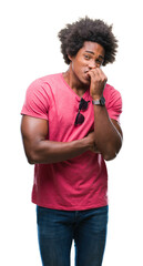 Poster - Afro american man over isolated background looking stressed and nervous with hands on mouth biting nails. Anxiety problem.