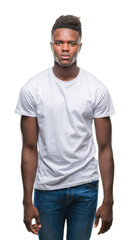 Sticker - Young african american man over isolated background with serious expression on face. Simple and natural looking at the camera.