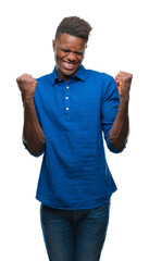 Sticker - Young african american man over isolated background very happy and excited doing winner gesture with arms raised, smiling and screaming for success. Celebration concept.