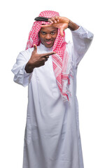 Poster - Young arabic african man wearing traditional keffiyeh over isolated background smiling making frame with hands and fingers with happy face. Creativity and photography concept.