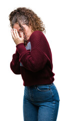 Wall Mural - Beautiful brunette curly hair young girl wearing glasses over isolated background with sad expression covering face with hands while crying. Depression concept.