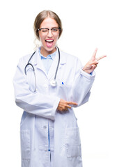 Sticker - Beautiful young blonde doctor woman wearing medical uniform over isolated background smiling with happy face winking at the camera doing victory sign. Number two.