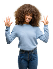 Sticker - African american woman wearing a sweater showing and pointing up with fingers number eight while smiling confident and happy.