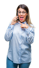 Canvas Print - Young beautiful business woman speaking calling using smartphone over isolated background very happy pointing with hand and finger