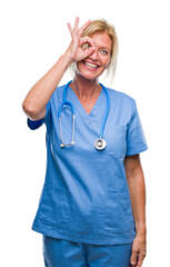 Sticker - Middle age blonde nurse surgeon doctor woman over isolated background doing ok gesture with hand smiling, eye looking through fingers with happy face.