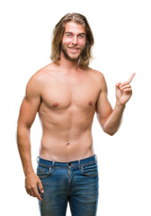 Sticker - Young handsome shirtless man with long hair showing sexy body over isolated background with a big smile on face, pointing with hand and finger to the side looking at the camera.