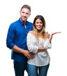 © Krakenimages.com - Young couple in love over isolated background smiling cheerful presenting and pointing with palm of hand looking at the camera.