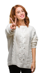 Canvas Print - Young beautiful woman over isolated background wearing winter sweater showing and pointing up with fingers number two while smiling confident and happy.