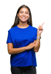 Canvas Print - Young beautiful arab woman over isolated background with a big smile on face, pointing with hand and finger to the side looking at the camera.