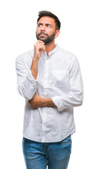 Sticker - Adult hispanic man over isolated background with hand on chin thinking about question, pensive expression. Smiling with thoughtful face. Doubt concept.