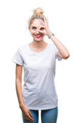 Sticker - Young beautiful blonde woman wearing white t-shirt over isolated background doing ok gesture with hand smiling, eye looking through fingers with happy face.