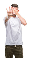 Poster - Young handsome man over isolated background covering eyes with hands and doing stop gesture with sad and fear expression. Embarrassed and negative concept.