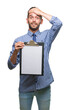 © Krakenimages.com - Young handsome business man holding clipboard over isolated background stressed with hand on head, shocked with shame and surprise face, angry and frustrated. Fear and upset for mistake.