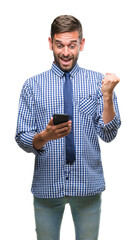 Wall Mural - Young hadsome man texting sending message using smartphone over isolated background screaming proud and celebrating victory and success very excited, cheering emotion