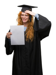 Canvas Print - Young redhead woman wearing graduate uniform holding degree stressed with hand on head, shocked with shame and surprise face, angry and frustrated. Fear and upset for mistake.