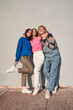 © Yakobchuk Olena - Vertical view of the trendy millennial teenagers looking at the camera with smile and posing