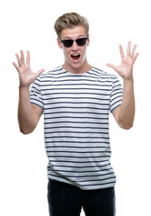 Wall Mural - Young handsome blond man wearing sunglasess very happy and excited, winner expression celebrating victory screaming with big smile and raised hands