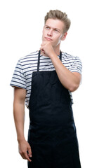 Poster - Young handsome blond man wearing apron serious face thinking about question, very confused idea