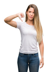 Sticker - Beautiful young woman wearing t-shirt and jeans with angry face, negative sign showing dislike with thumbs down, rejection concept