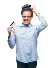 Sticker - Young african american girl holding credit card over isolated background annoyed and frustrated shouting with anger, crazy and yelling with raised hand, anger concept