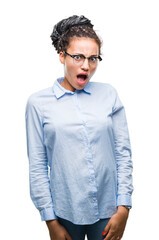 Wall Mural - Young braided hair african american business girl wearing glasses over isolated background afraid and shocked with surprise expression, fear and excited face.