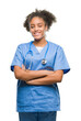 © Krakenimages.com - Young afro american doctor woman over isolated background happy face smiling with crossed arms looking at the camera. Positive person.