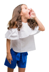 Wall Mural - Brunette hispanic girl shouting and screaming loud to side with hand on mouth. Communication concept.