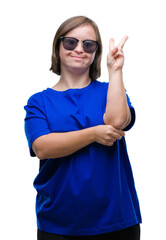 Canvas Print - Young adult woman with down syndrome wearing sunglasses over isolated background smiling with happy face winking at the camera doing victory sign. Number two.