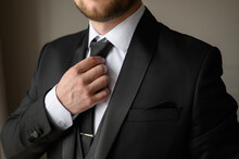 A Man In A Business Suit Puts On And Straightens His Tie With A Clip. Wedding Day Concept,fashion, Business, Male Style.