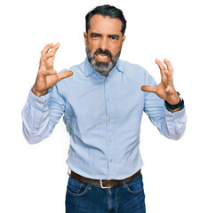 Wall Mural - Middle aged man with beard wearing business shirt shouting frustrated with rage, hands trying to strangle, yelling mad