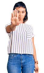 Sticker - Young woman wearing casual clothes doing stop sing with palm of the hand. warning expression with negative and serious gesture on the face.