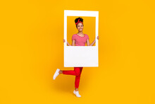 Full Body Photo Of Pretty Young Girl Hold Social Media Photo Frame Dressed Stylish Red Striped Outfit Isolated On Yellow Color Background